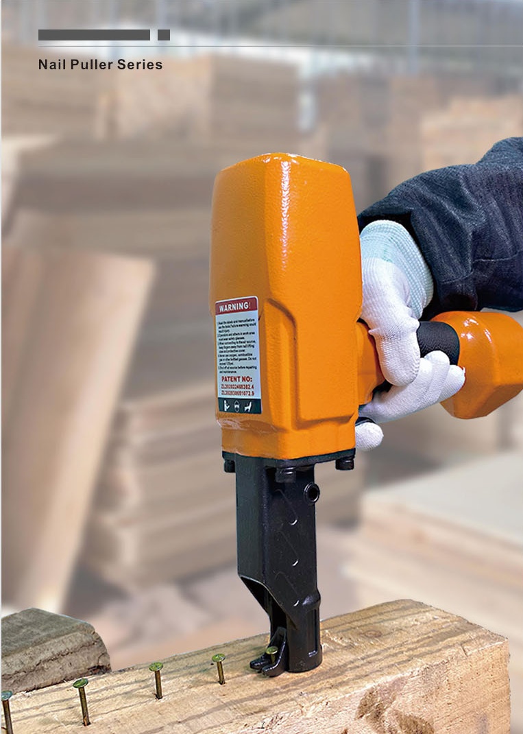 A pneumatic nail puller removing nails from a wooden pallet